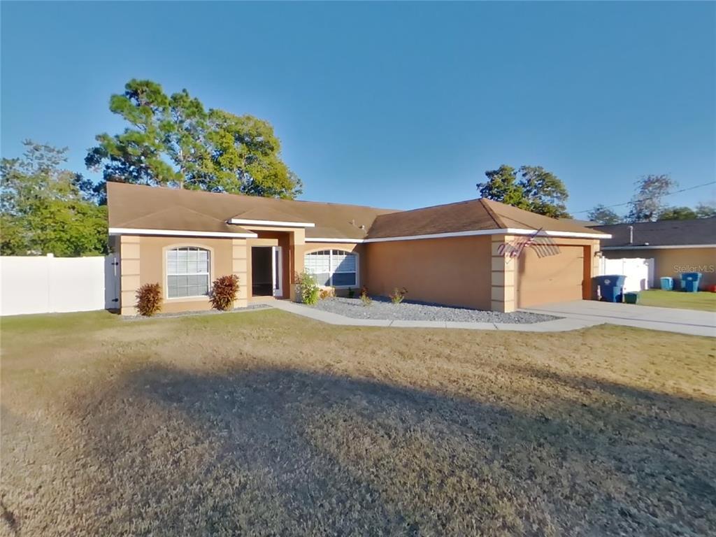 a view of a house with a backyard