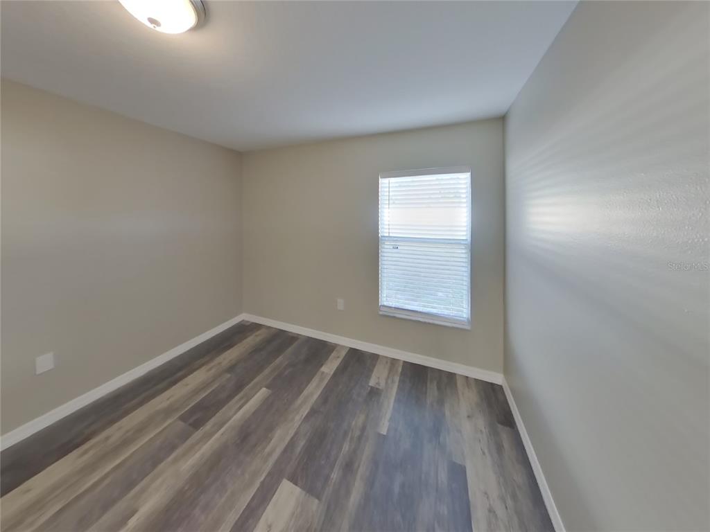 Undisclosed Address Spring Hill, FL 34608 - Photo 12 of 15 wooden floor in an empty room with a window