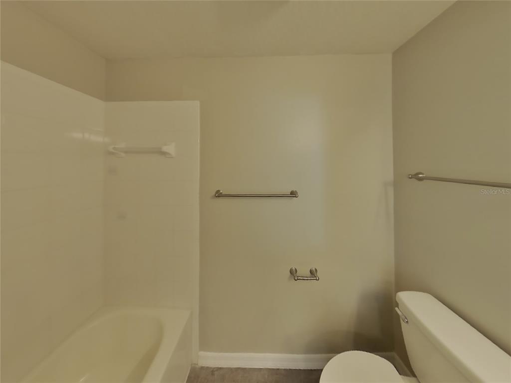 Undisclosed Address Spring Hill, FL 34608 - Photo 14 of 15 a bathroom with a toilet and a shower
