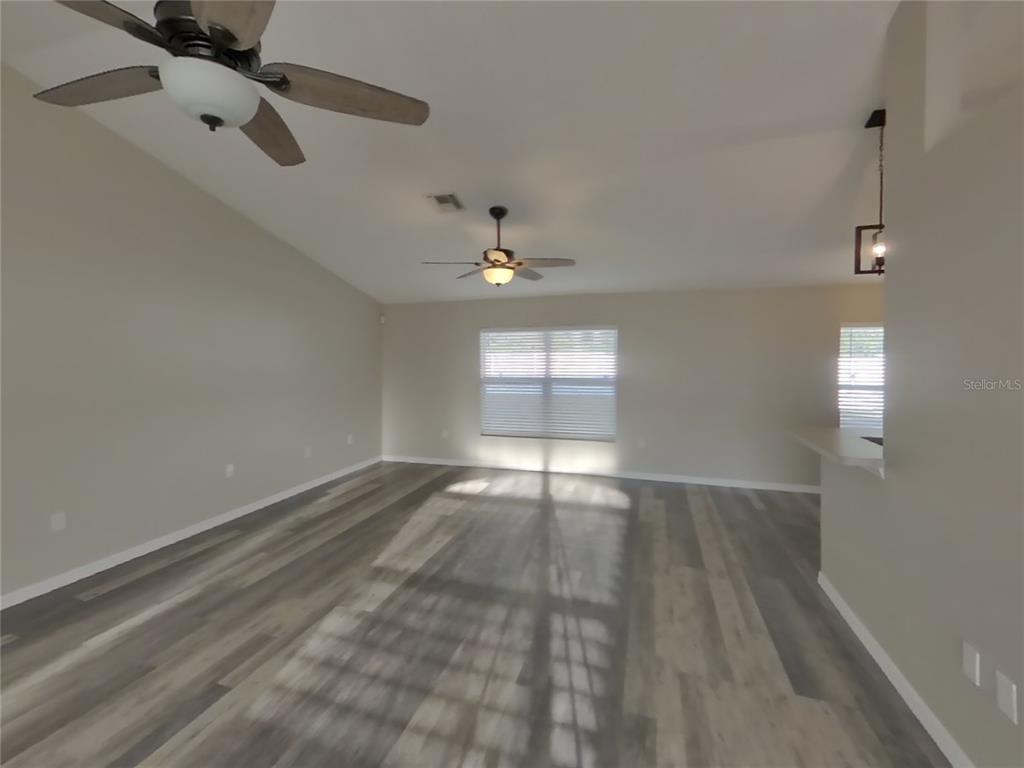 Undisclosed Address Spring Hill, FL 34608 - Photo 3 of 15 wooden floor in an empty room with a window