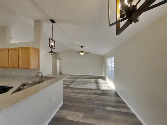 a view of a kitchen with a sink and cabinet
