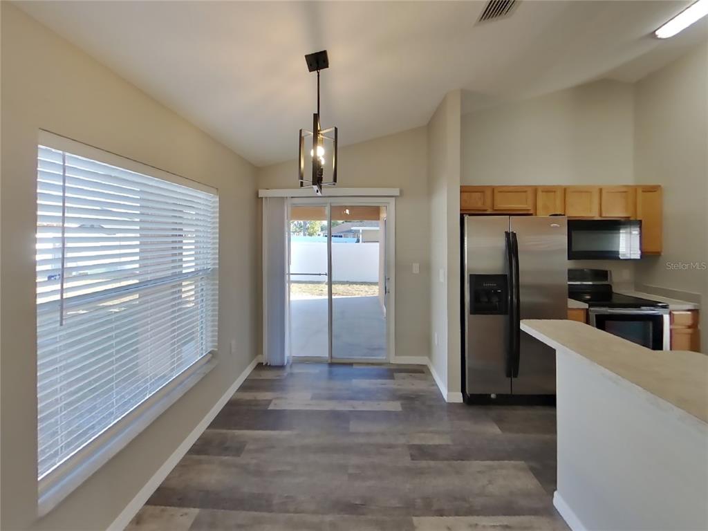 Undisclosed Address Spring Hill, FL 34608 - Photo 5 of 15 a view of a kitchen from the hallway
