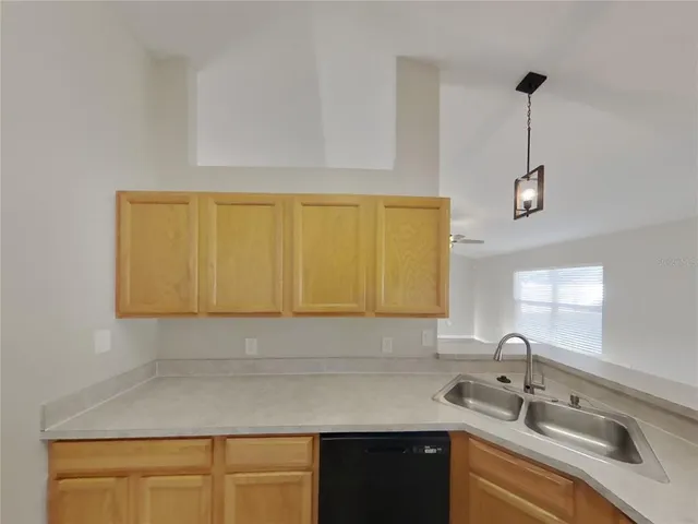 a kitchen with a sink and a refrigerator