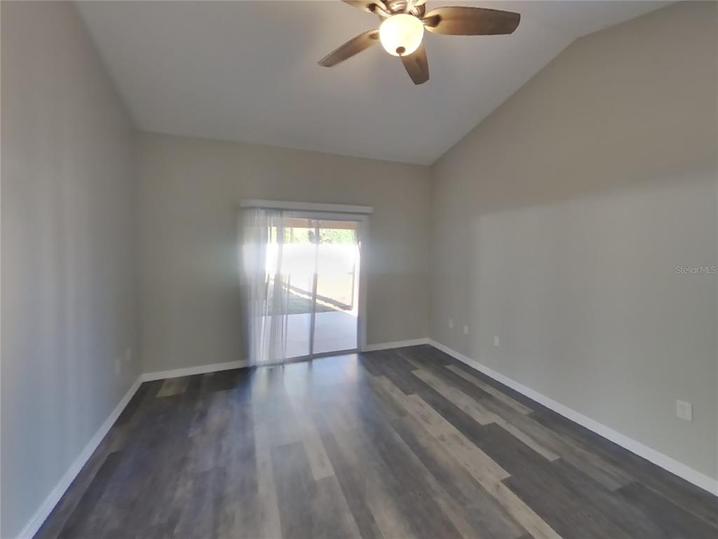 Undisclosed Address Spring Hill, FL 34608 - Photo 7 of 15 wooden floor in an empty room with a window