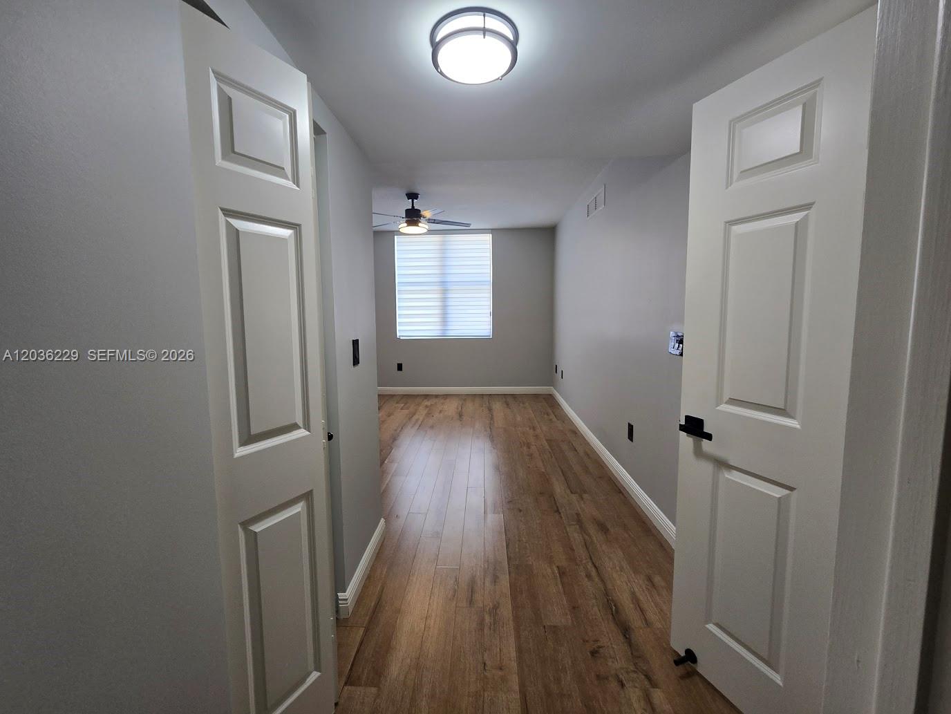 888 Douglas Road, Unit 605 Coral Gables, FL 33134 - Photo 11 of 21 wooden floor in an empty room with a window