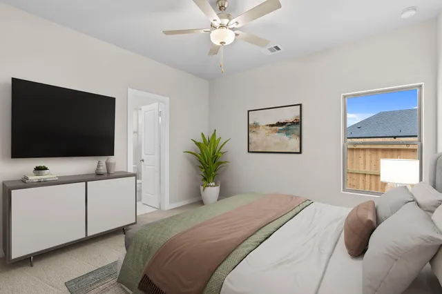 a bedroom with a bed and a flat screen tv