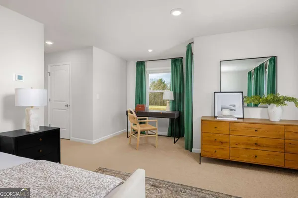 a living room with furniture and a dresser