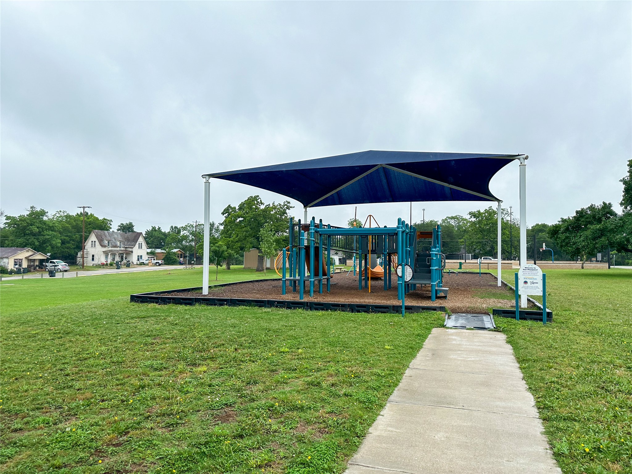 608 Lamar Street Luling, TX 78648 - Photo 5 of 7 Community playground featuring a shade structure and multi-level play equipment
