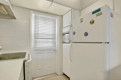 a white refrigerator freezer and a window