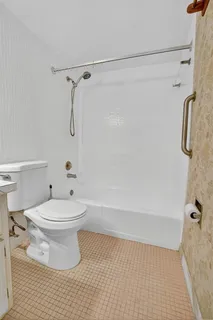 a bathroom with a toilet and a shower