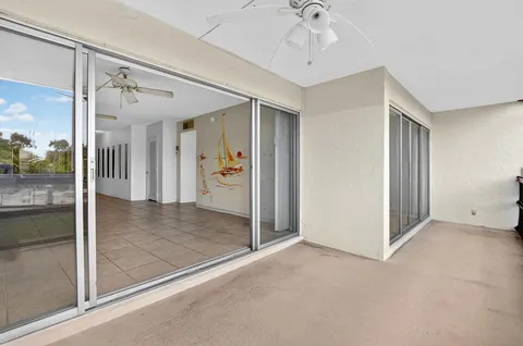 a view of a hallway view with living room and chandelier