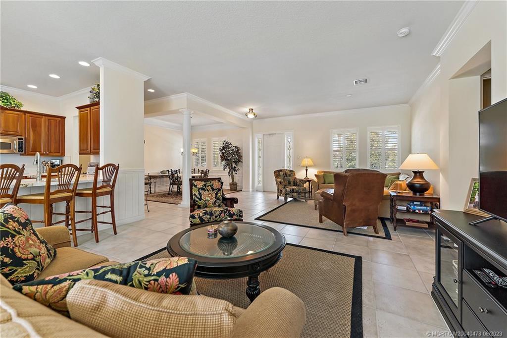 1162 Tropical Drive Jupiter, FL 33458 - Photo 12 of 43 a living room with furniture kitchen view and a large mirror