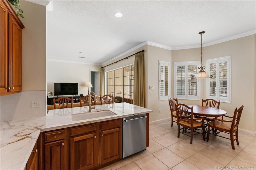 1162 Tropical Drive Jupiter, FL 33458 - Photo 16 of 43 a group of chairs sitting in a kitchen and living room