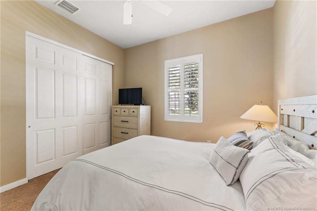 1162 Tropical Drive Jupiter, FL 33458 - Photo 22 of 43 a bedroom with a bed and a window