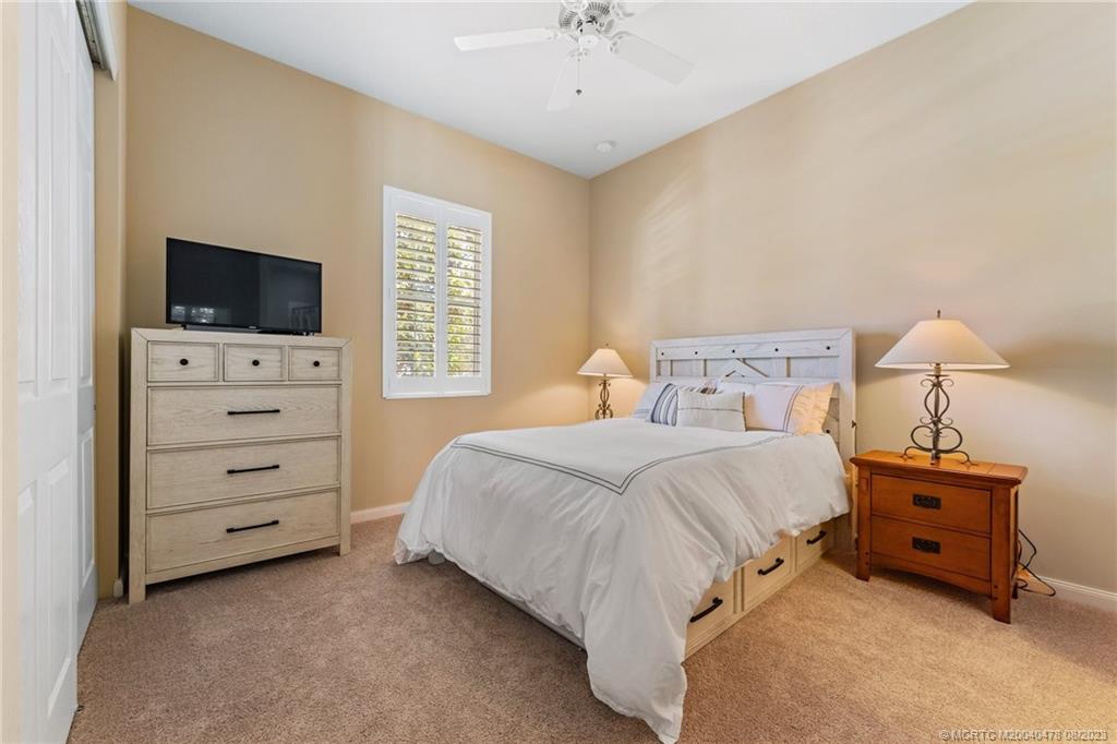 1162 Tropical Drive Jupiter, FL 33458 - Photo 23 of 43 a bedroom with a bed and a television