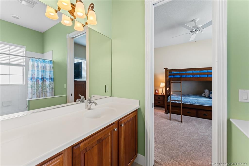 1162 Tropical Drive Jupiter, FL 33458 - Photo 26 of 43 a bathroom with a sink a vanity and a mirror