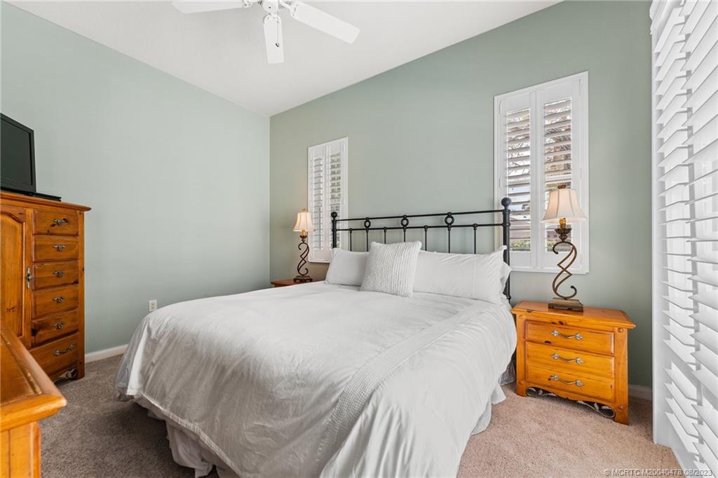 1162 Tropical Drive Jupiter, FL 33458 - Photo 33 of 43 a bedroom with a bed and a tv