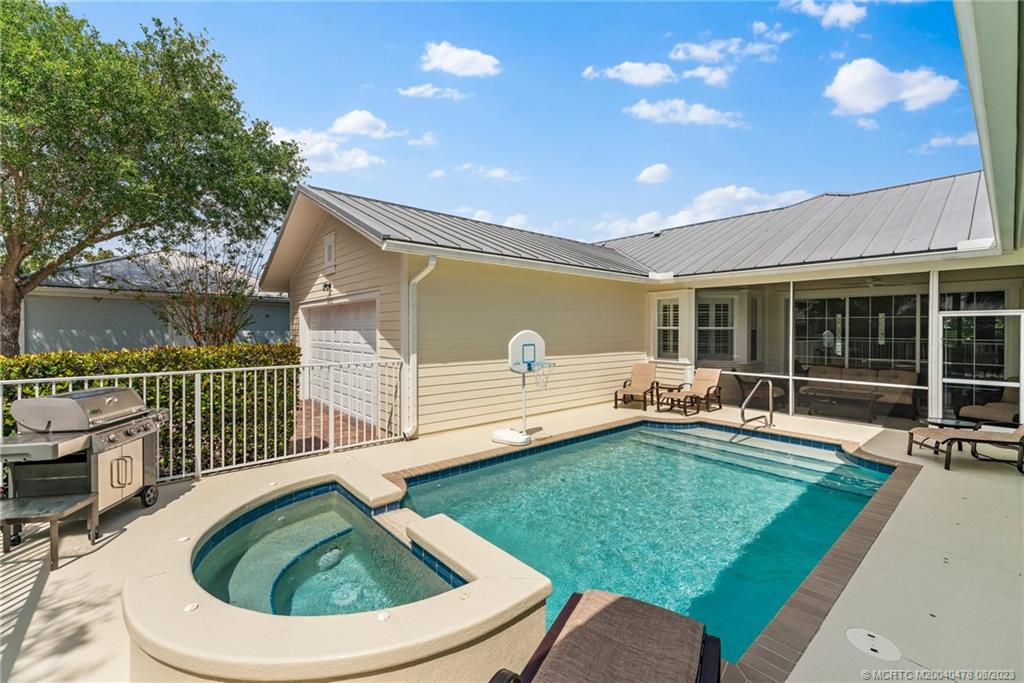 1162 Tropical Drive Jupiter, FL 33458 - Photo 35 of 43 a view of a house with backyard porch and sitting area