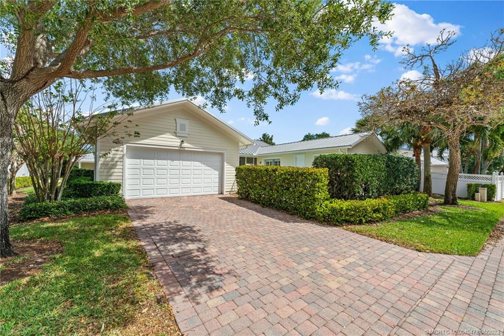 1162 Tropical Drive Jupiter, FL 33458 - Photo 37 of 43 a front view of a house with a yard and a garage