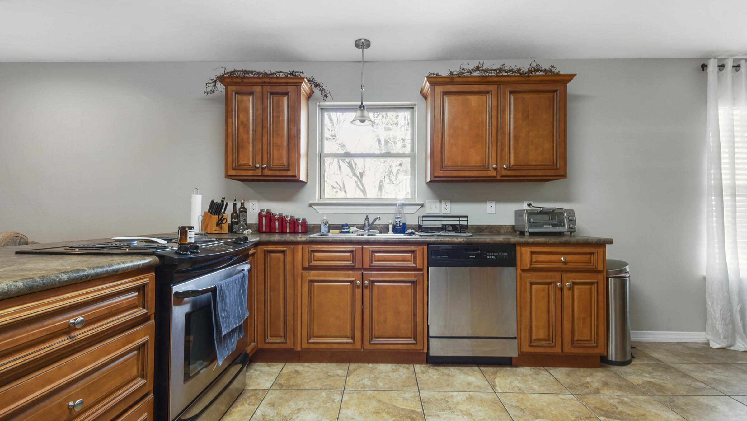 908 Valley Road Crestview, FL 32539 - Photo 16 of 22 a kitchen with stainless steel appliances granite countertop a stove a sink and a microwave