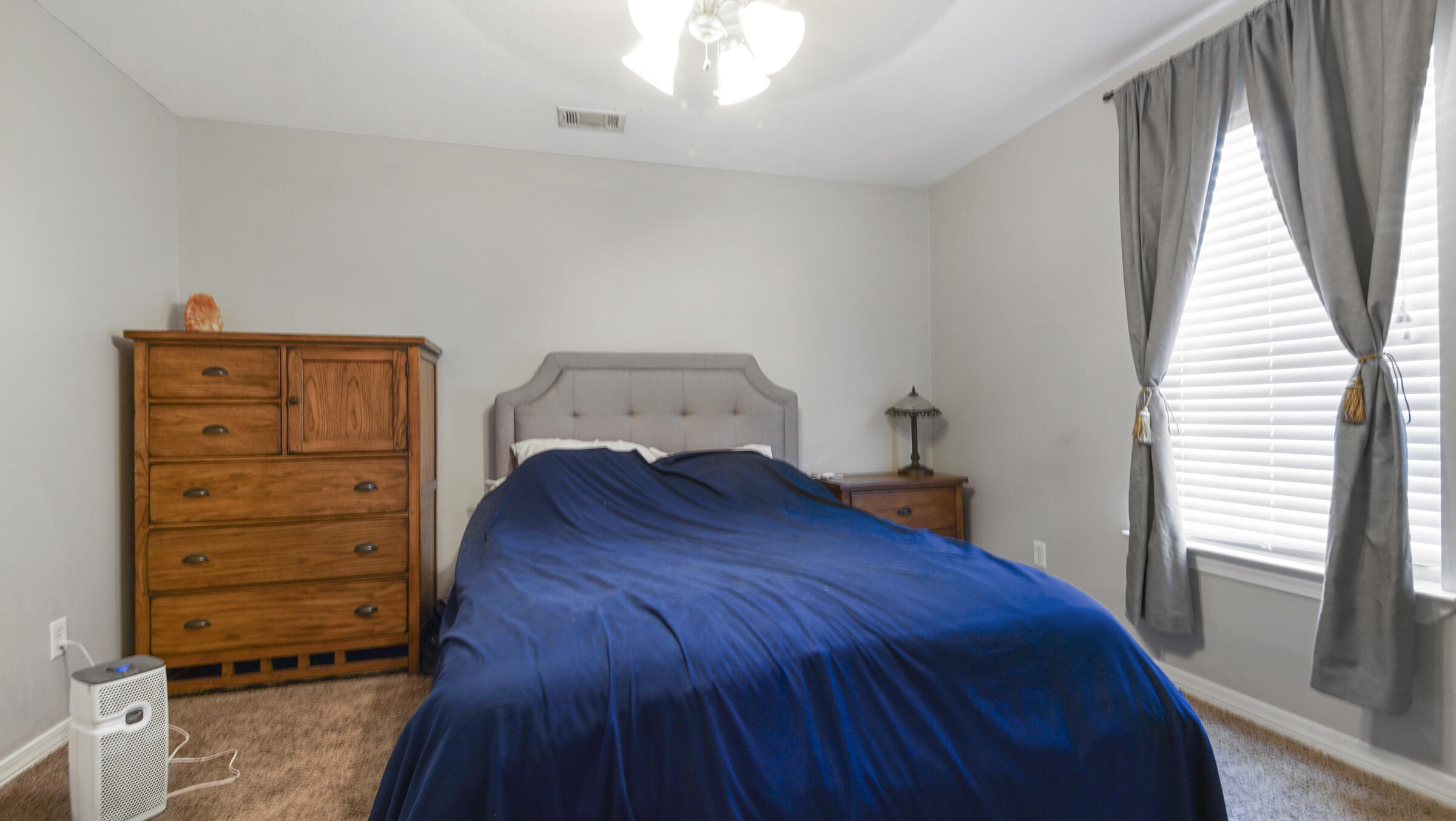 908 Valley Road Crestview, FL 32539 - Photo 5 of 22 a bedroom with a bed and a window