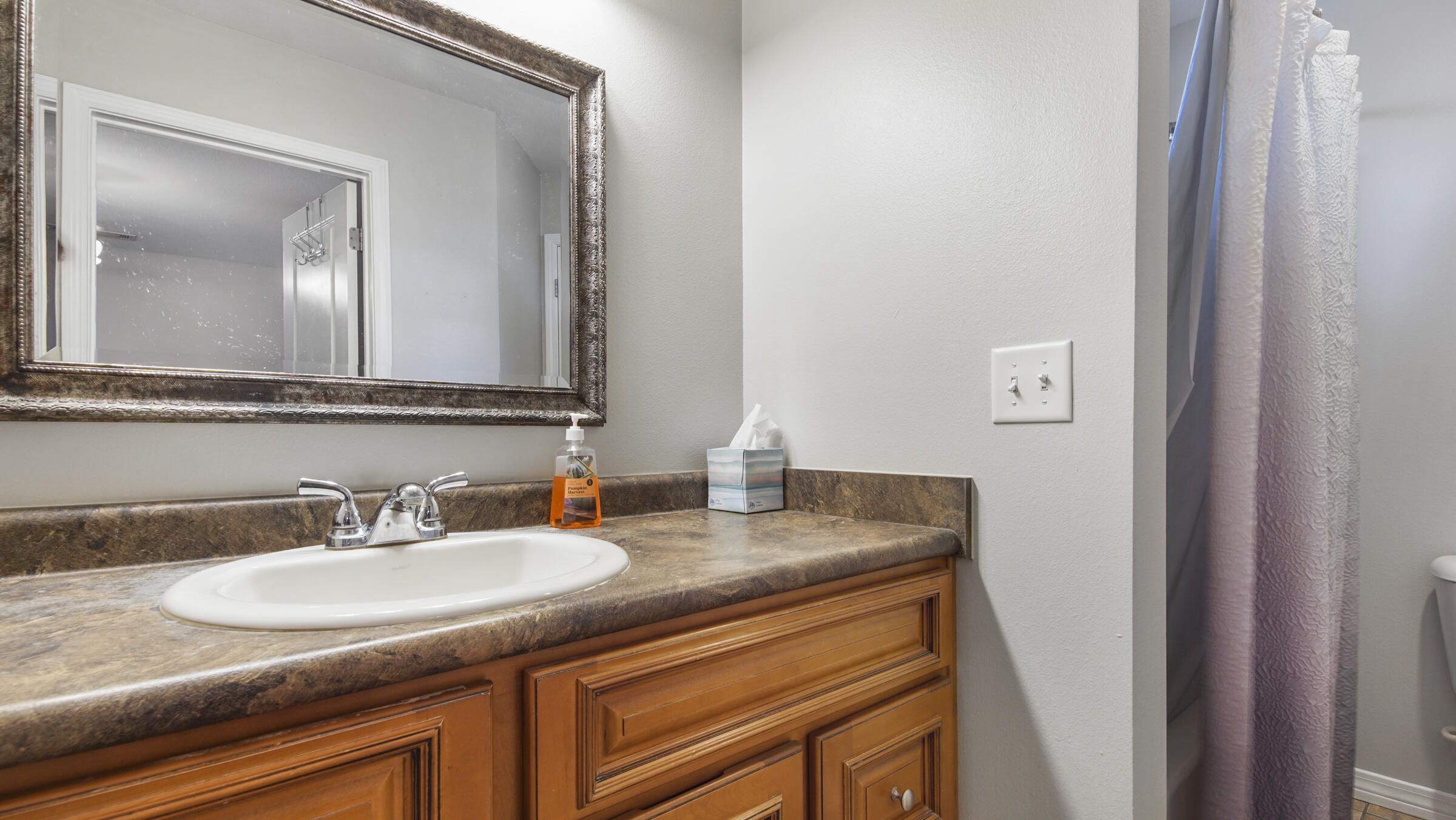 908 Valley Road Crestview, FL 32539 - Photo 6 of 22 a bathroom with a granite countertop sink and a mirror