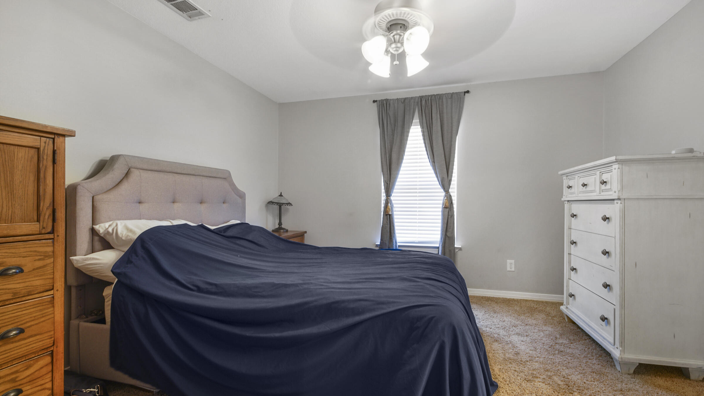908 Valley Road Crestview, FL 32539 - Photo 8 of 22 a spacious bedroom with a bed and a window