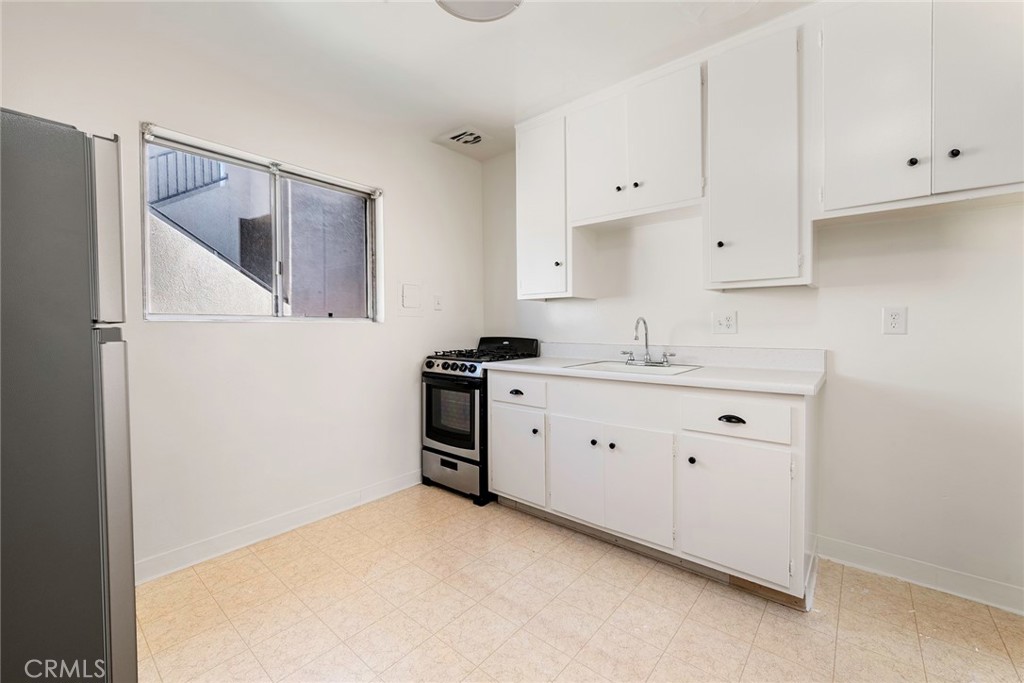 24 Roswell Avenue Long Beach, CA 90803 - Photo 8 of 13 a kitchen with cabinets stainless steel appliances a sink and dishwasher