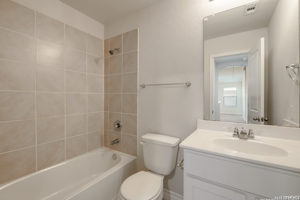 2943 Pemberton Post San Antonio, TX 78245 - Photo 16 of 19 a bathroom with a sink toilet and shower