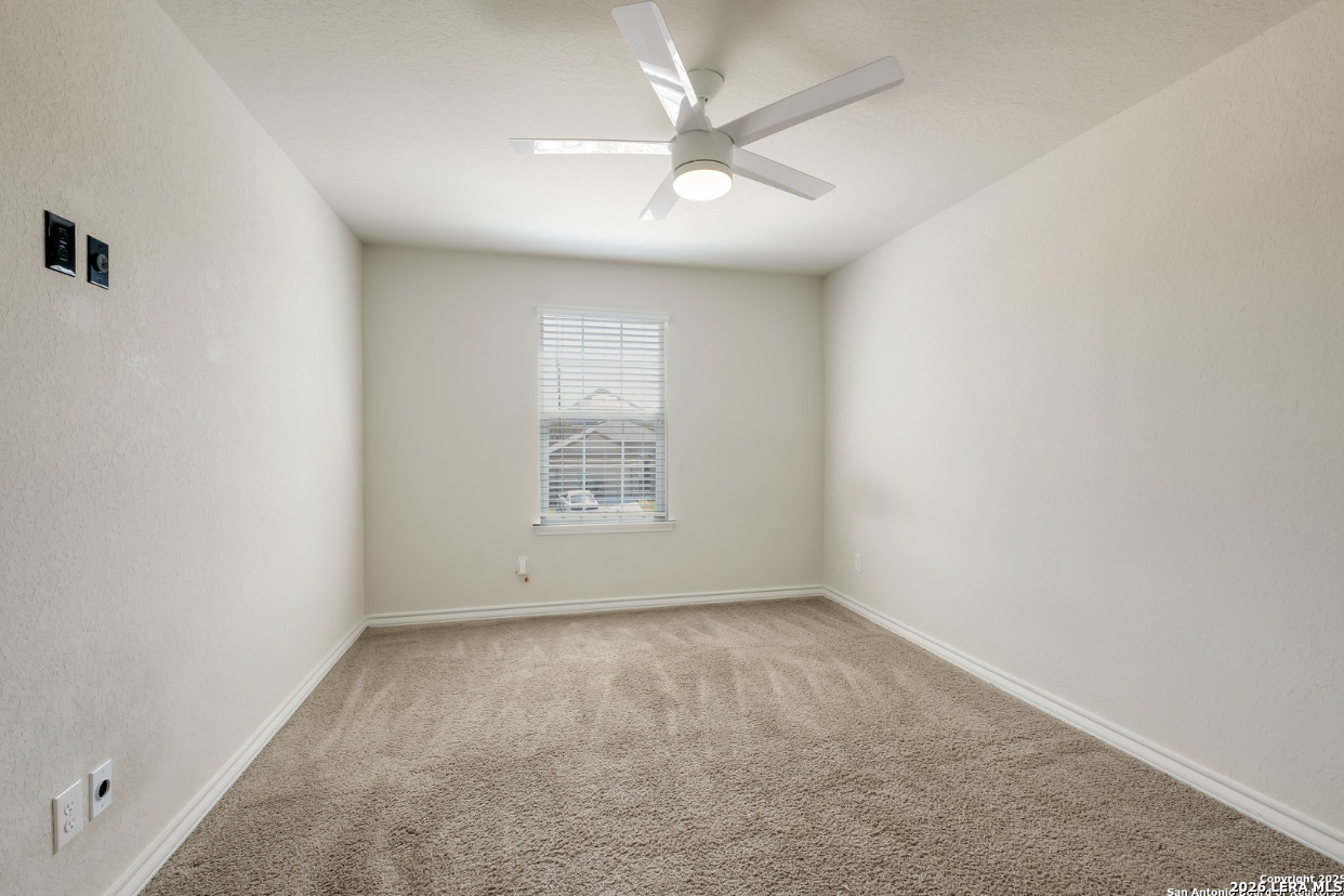 2943 Pemberton Post San Antonio, TX 78245 - Photo 17 of 19 an empty room with a window and a fan