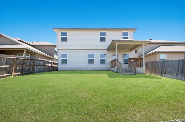a front view of house with yard and seating space