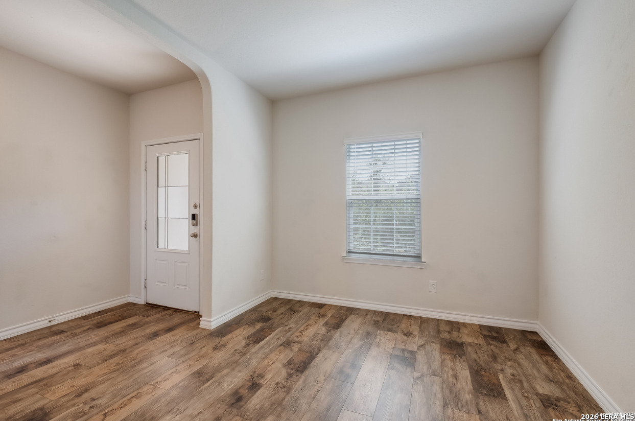 2943 Pemberton Post San Antonio, TX 78245 - Photo 2 of 19 an empty room with wooden floor and windows