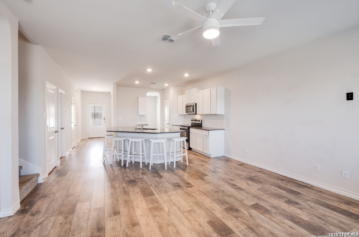 2943 Pemberton Post San Antonio, TX 78245 - Photo 4 of 19 a view of kitchen with wooden floor and window