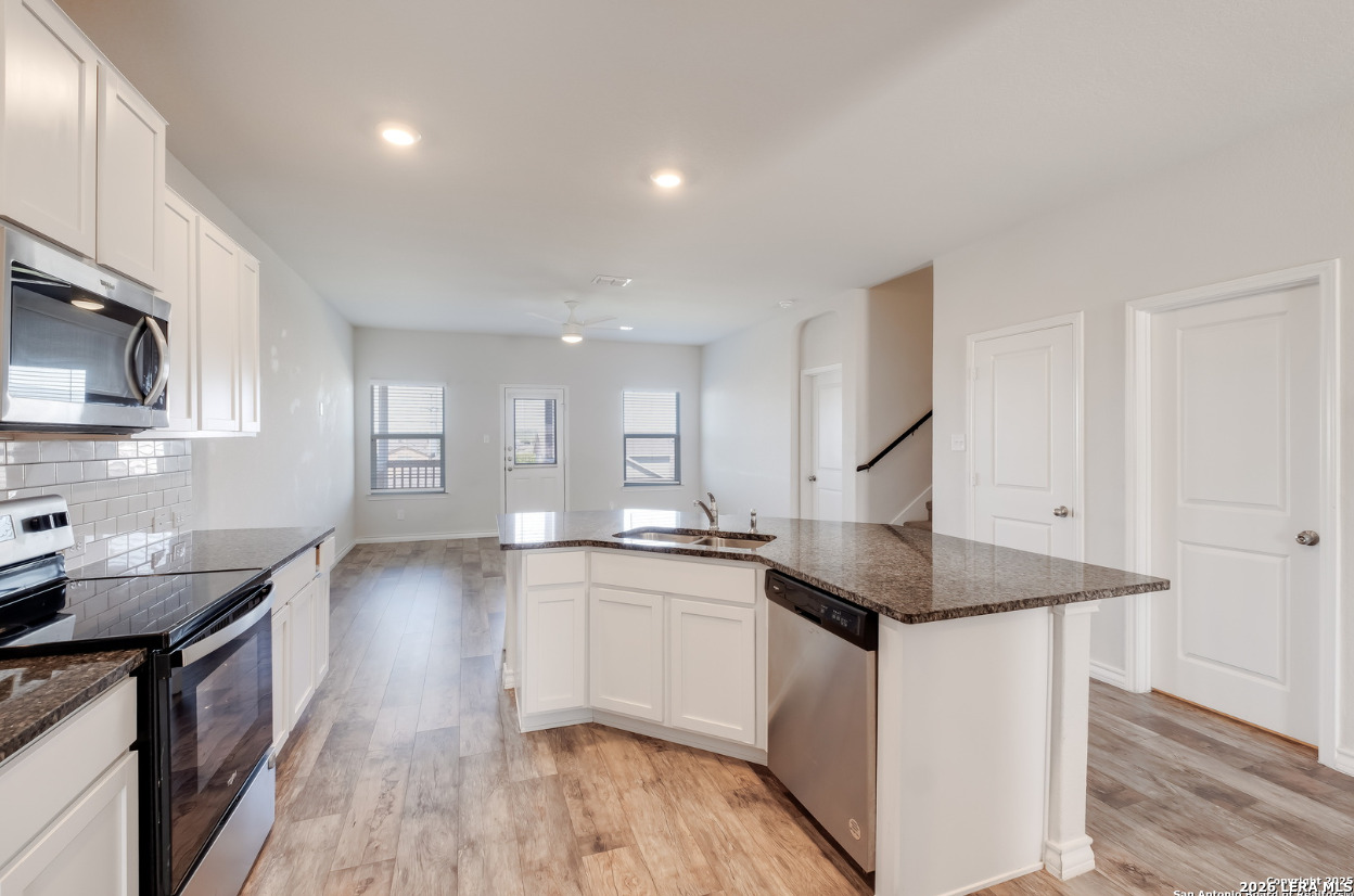 2943 Pemberton Post San Antonio, TX 78245 - Photo 8 of 19 a kitchen with granite countertop a sink a counter top space stainless steel appliances and cabinets
