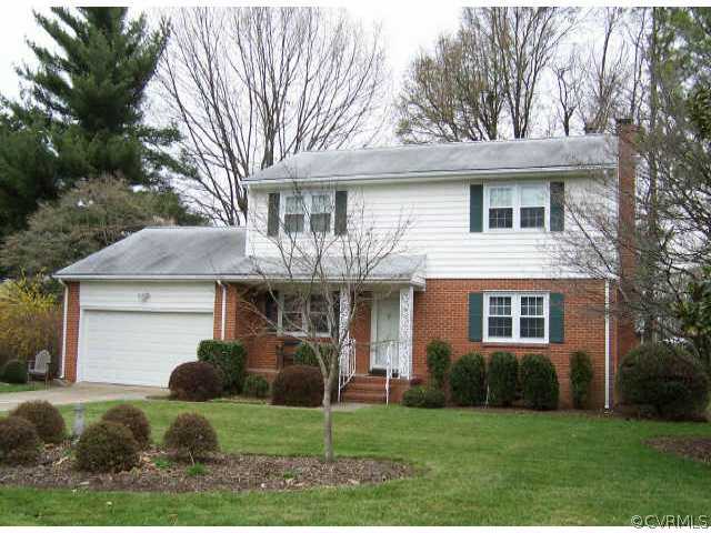 1310 Covington Road Colonial Heights, VA 23834 - Photo 1 of 1 a front view of a house with a garden and trees