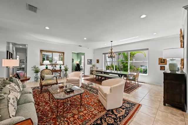 a living room with furniture large window and a table