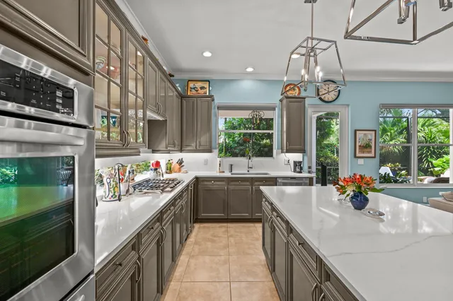 a kitchen with a sink counter top space appliances and cabinets
