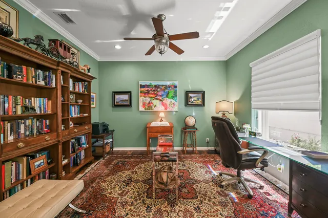 a living room with furniture a rug and a book shelf