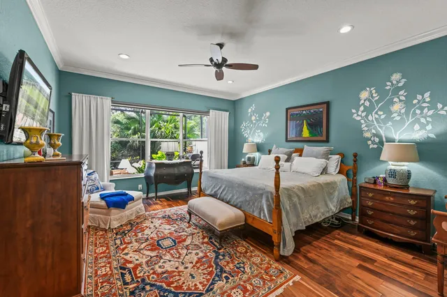 a bedroom with a bed and glass walk in closet