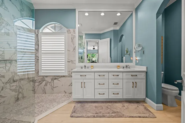 a spacious bathroom with a granite countertop sink and a mirror