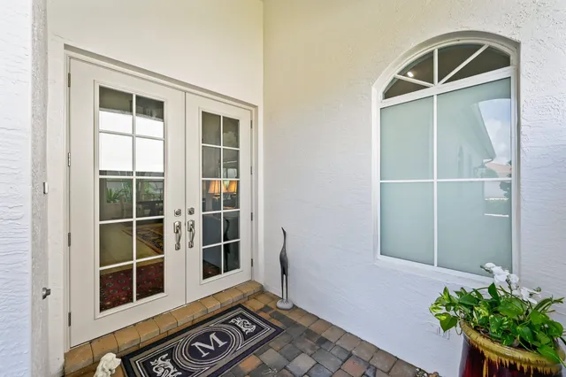 a front view of a house with a potted plant