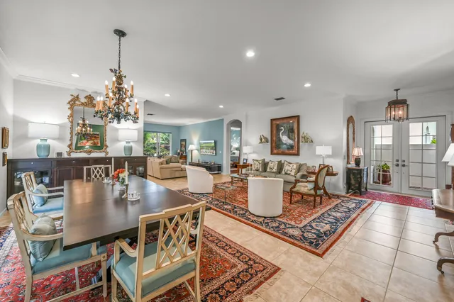 a living room with dining room and wooden floor