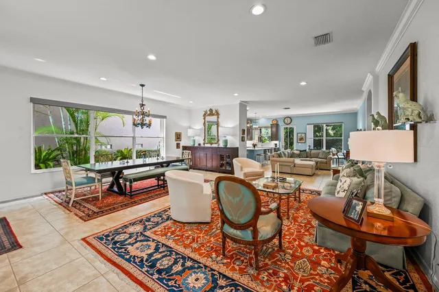 a living room with furniture a rug and a large window