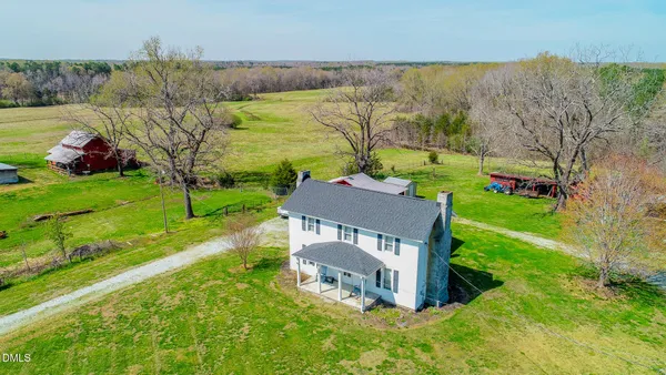 an aerial view of a house with big yard