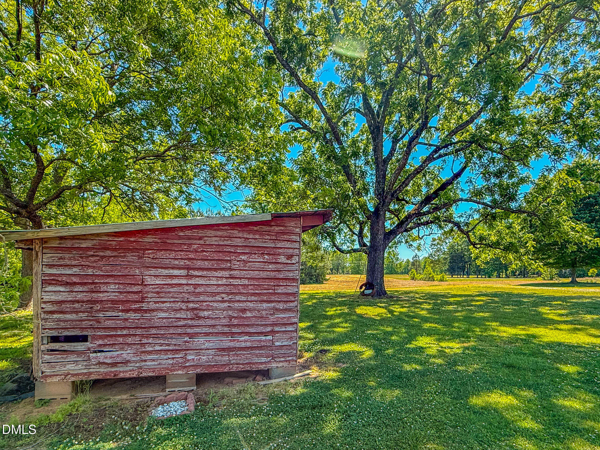 1001 Charlie Reade Road Timberlake, NC 27583 - Photo 57 of 64 a view of a backyard with a large tree