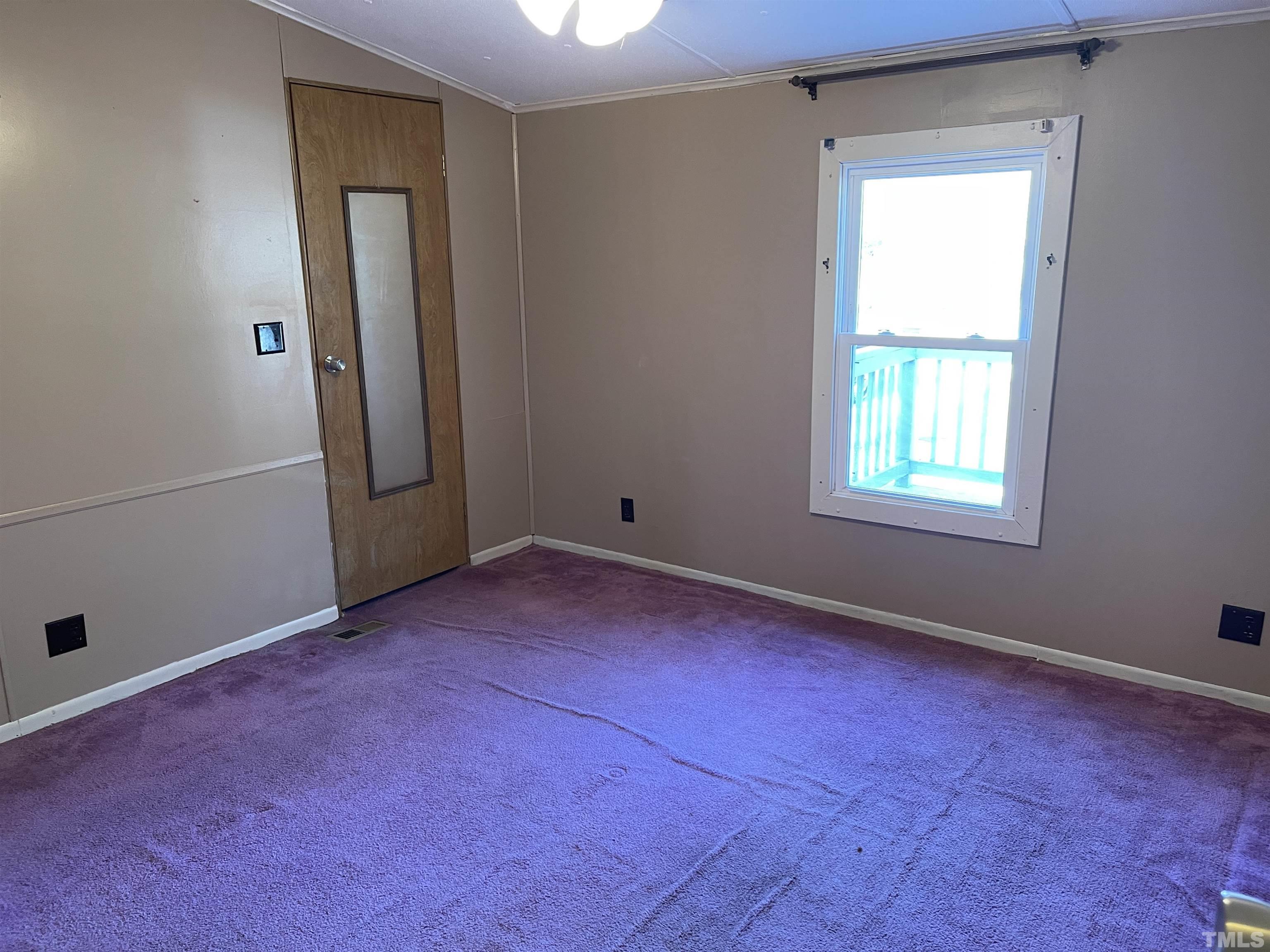 1605 Ridge Road Zebulon, NC 27597 - Photo 14 of 19 an empty room with windows