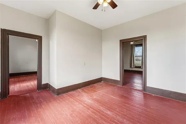an empty room with wooden floor and closet