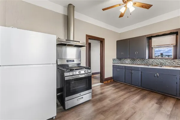 a kitchen with stainless steel appliances granite countertop a stove a refrigerator and a sink
