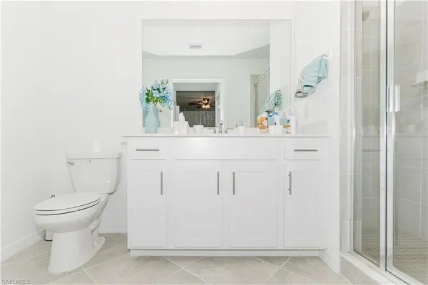 a bathroom with a sink a toilet and mirror