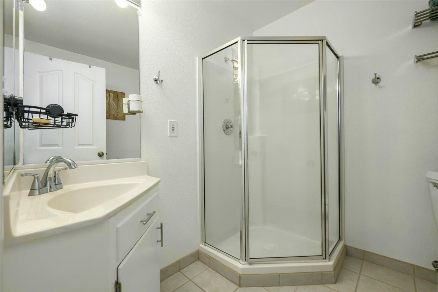 3640 Omo Ranch Road Somerset, CA 95684 - Photo 28 of 57 a bathroom with a shower sink and mirror
